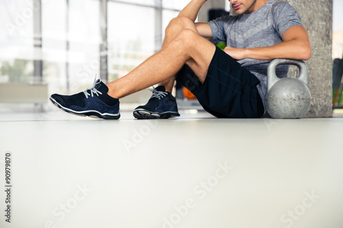 Man sitting on the floor at gym © Drobot Dean