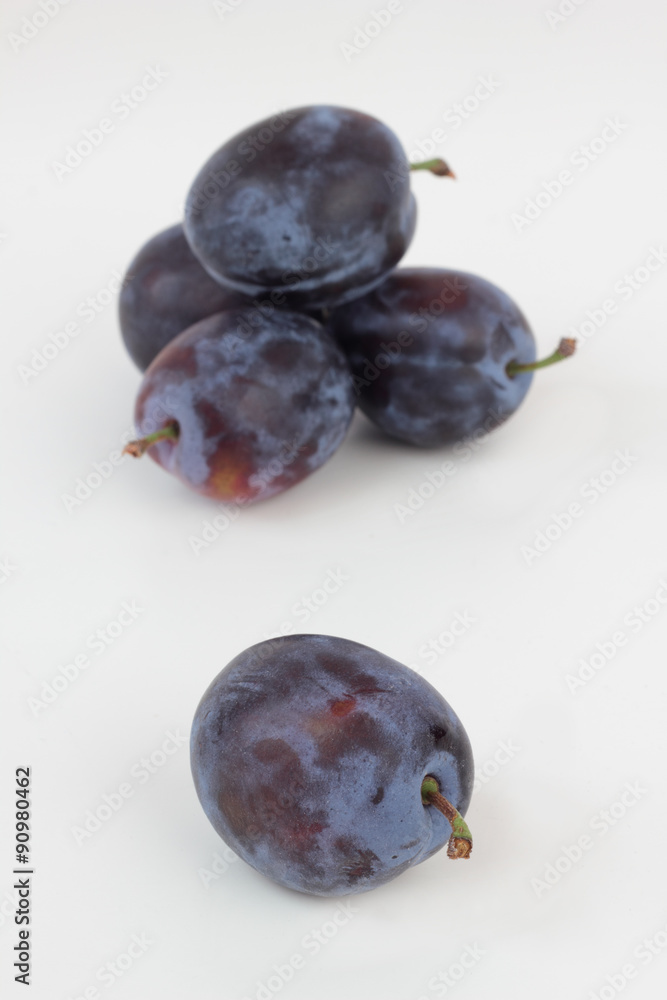 Closeup of ripe plums isolated on white.