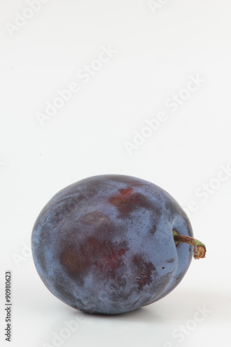 Closeup of ripe plum isolated on white.