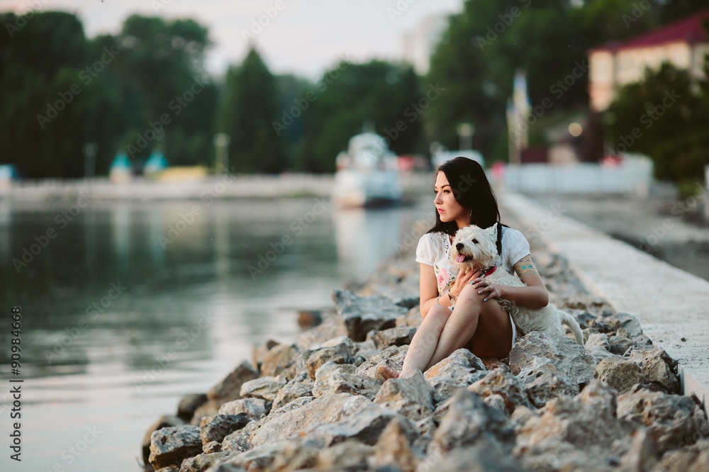 Fototapeta premium girl with a dog on the promenade