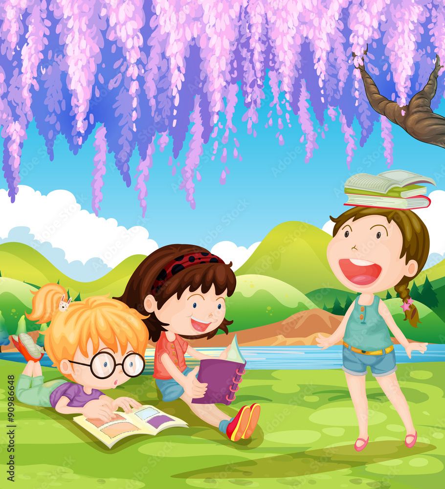 Children reading books under the tree
