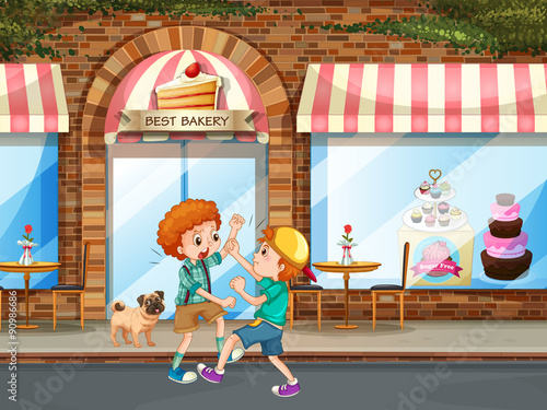 Two boys fighting in the street