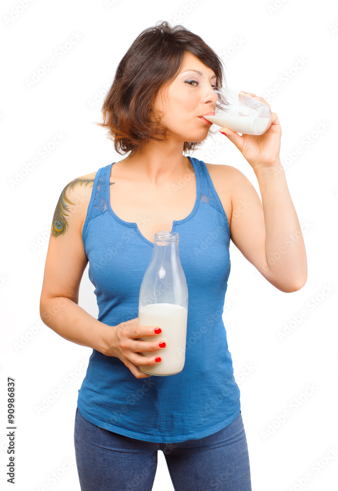 Real Caucasian young woman drinking milk from a bottle Real Caucasian young woman drinking milk from a bottle