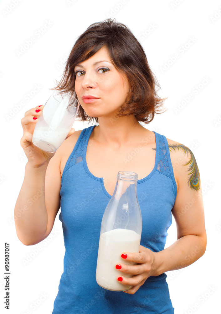 Real Caucasian young woman drinking milk from a bottle Real Caucasian young woman drinking milk from a bottle