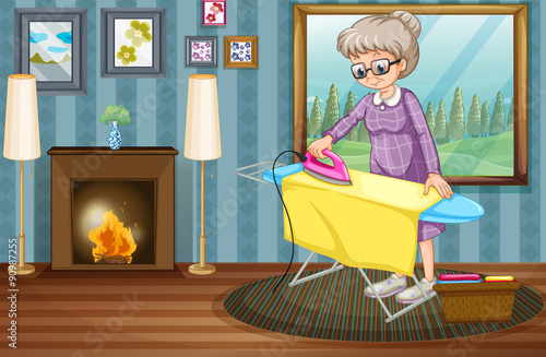 Old lady ironing clothes in the house