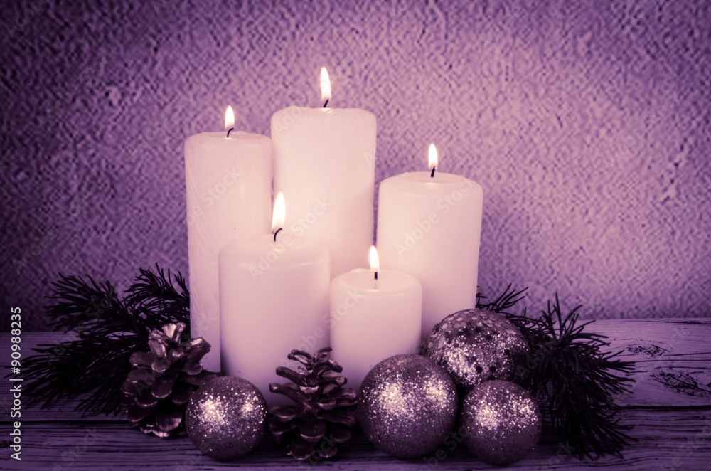 burning candles and white baubles