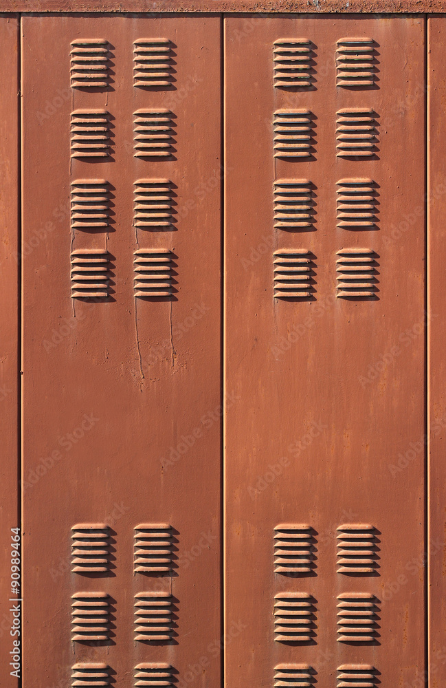 Fototapeta premium Background with rusty brown metal ventilation grille doors