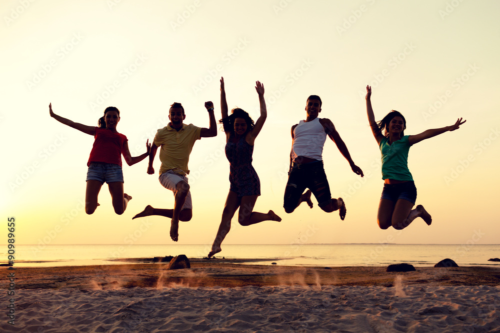 smiling friends dancing and jumping on beach smiling friends dancing and jumping on beach