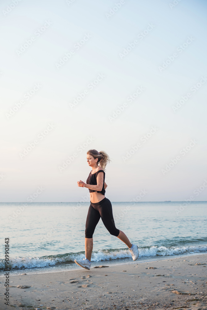 Running woman. Female runner jogging during the sunrise on beach. Running woman. Female runner jogging during the sunrise on beach.
