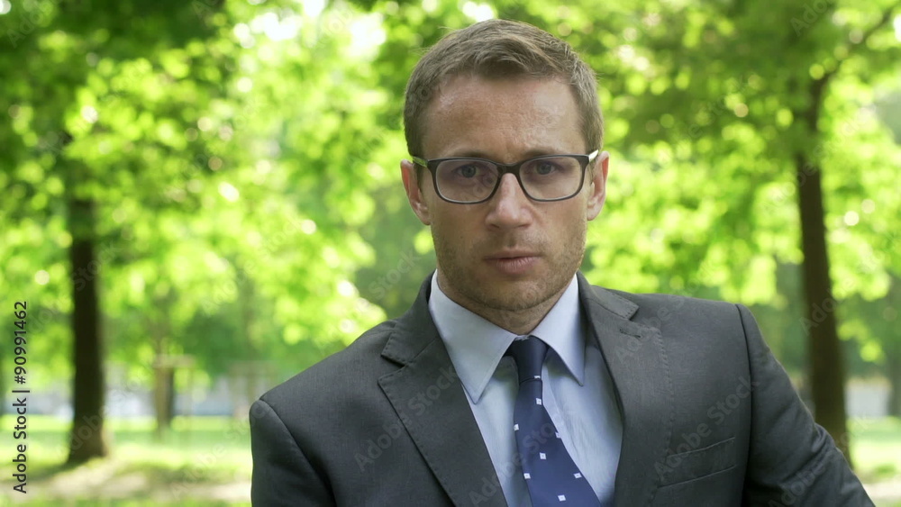 Upset businessman looking to the camera in the park
Upset businessman looking to the camera in the park