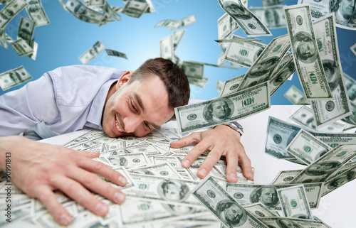 Vászonkép happy businessman with heap of money