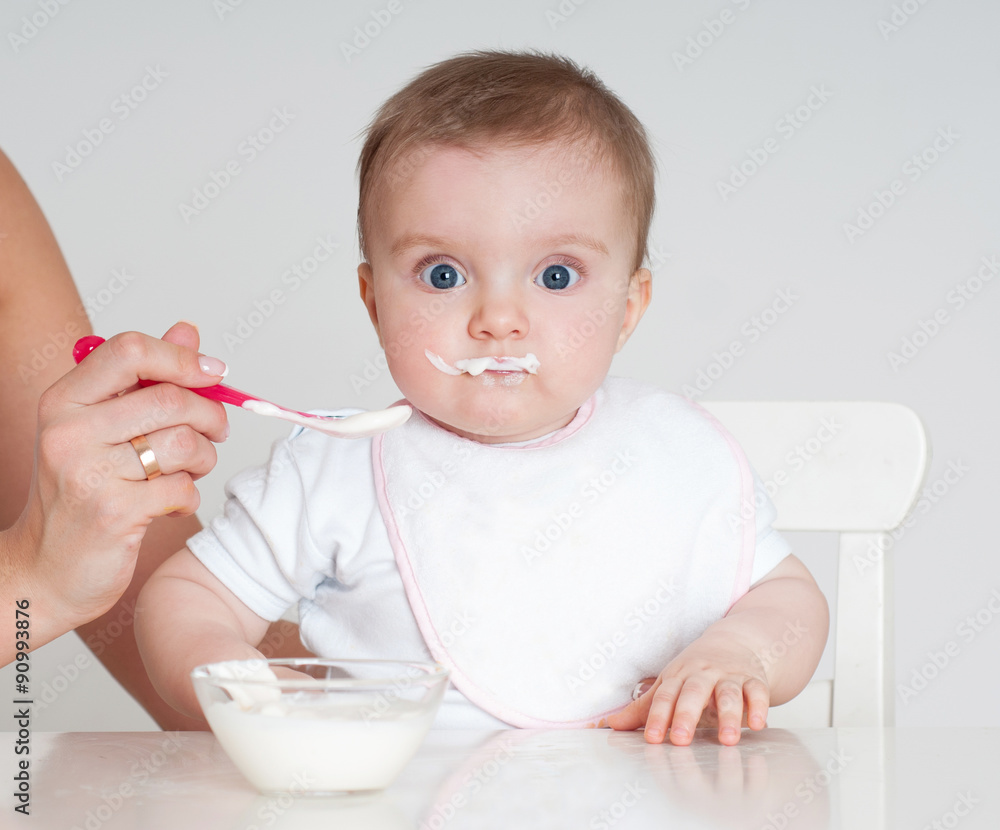 Mother feeding baby with a spoon. Spoon-feed. Mother feeding baby with a spoon. Spoon-feed.
