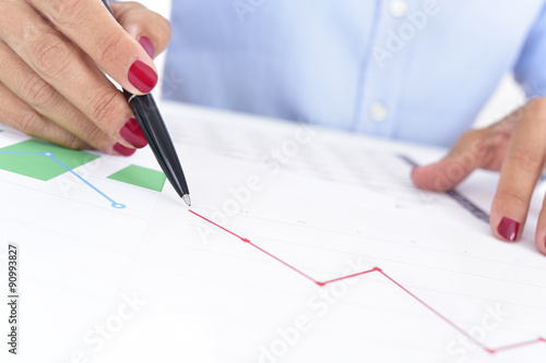 businesswoman with a chart with a downward trend