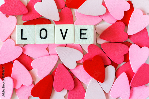 Pile of red and pink hearts with the word love photo