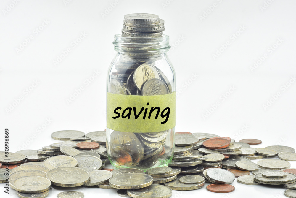 Isolated coins in jar with saving label - financial concept Isolated coins in jar with saving label - financial concept