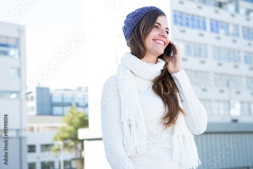 Brunette with warm clothes on the phone  © WavebreakmediaMicro