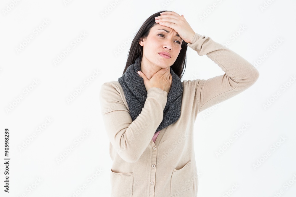 Sick brunette touching her throat and her head Sick brunette touching her throat and her head
