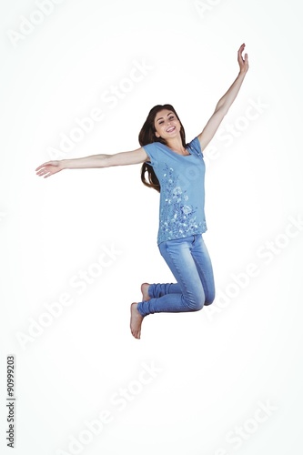 Pretty brunette jumping and smiling