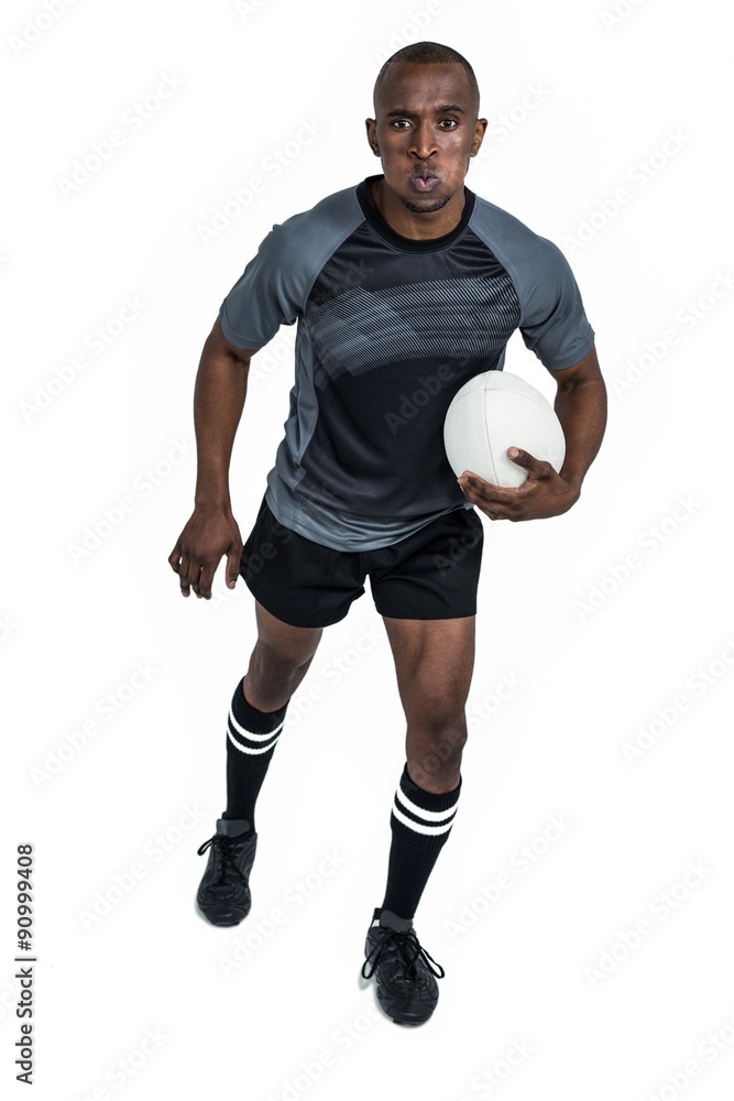 Portrait of determined sportsman holding rugby ball