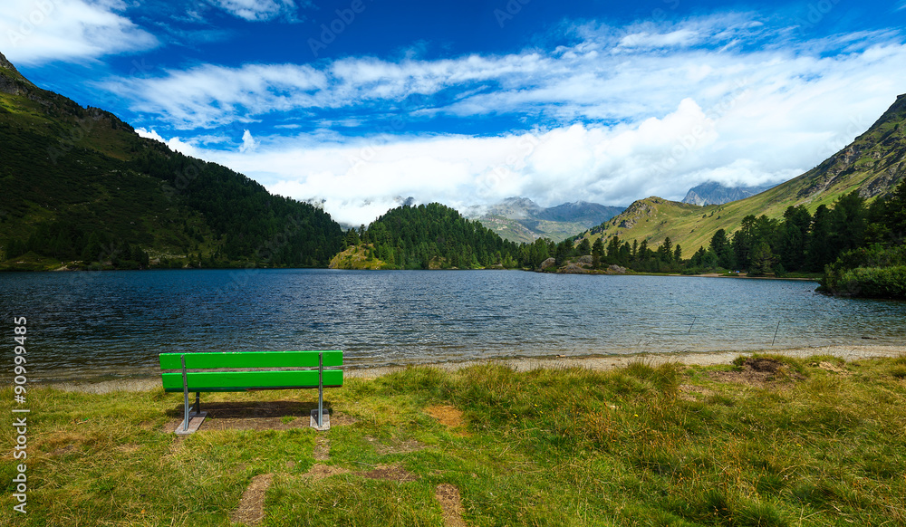 Bench in front of an alpine lake Bench in front of an alpine lake