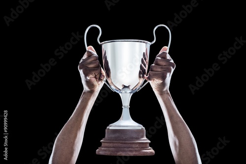 Cropped hand of athlete holding trophy