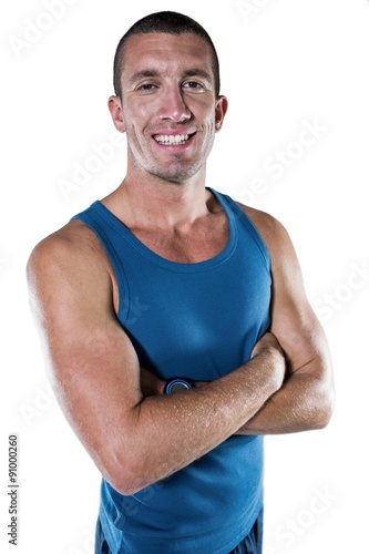 Smiling athlete with arms crossed