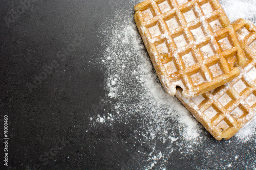 Waffles with sugar on slate table photo