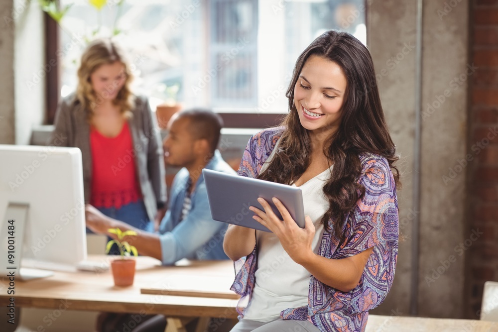 Smiling businesswoman using digital tablet in office Smiling businesswoman using digital tablet in office