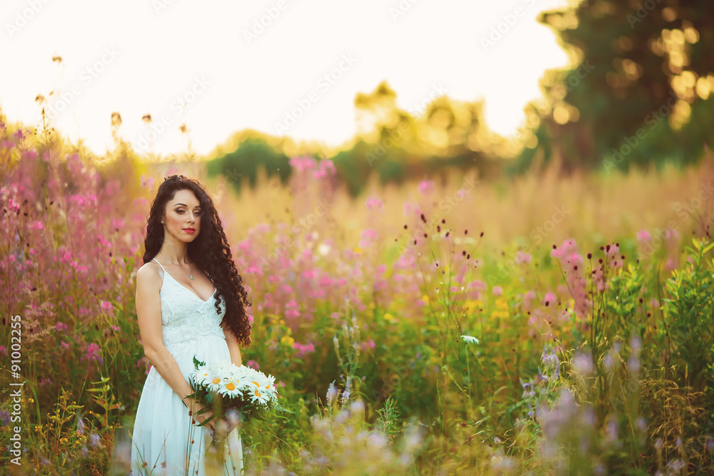beautiful girl in the field, with long black hair beautiful girl in the field, with long black hair