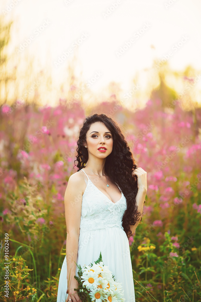 beautiful young girl standing with a bouquet in the hands holdin beautiful young girl standing with a bouquet in the hands holdin