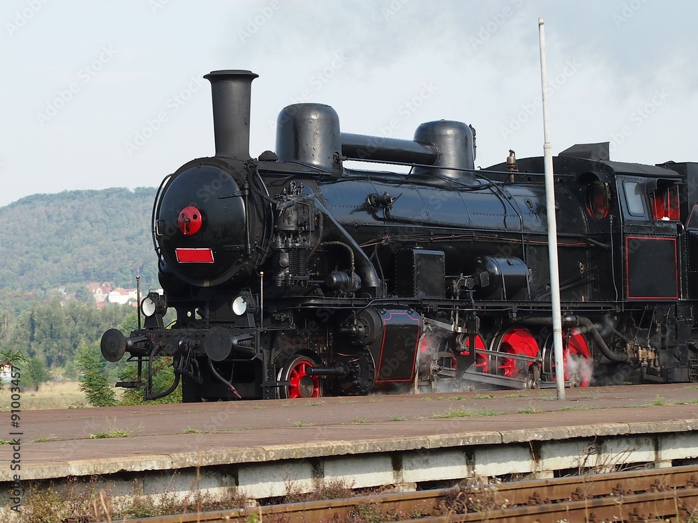 Fototapeta premium Black steam locomotive in motion.