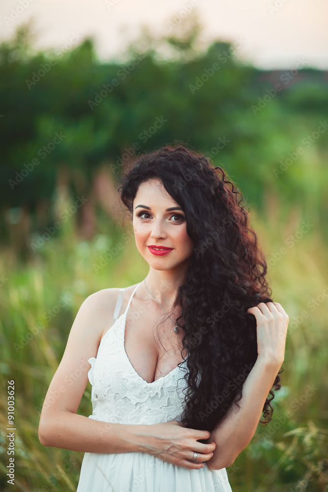 Happy woman in spring field. Young girl relax outdoors. Freedom Happy woman in spring field. Young girl relax outdoors. Freedom
