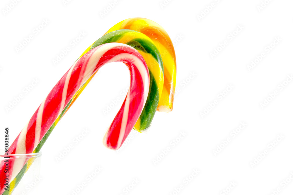 Christmas candy canes red yellow green isolated on white background
