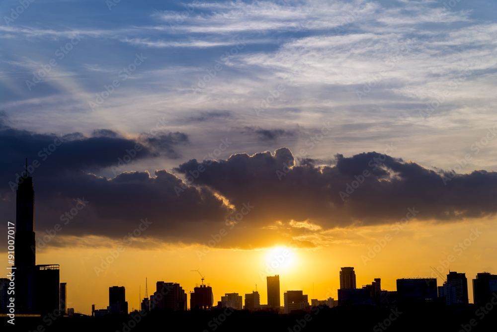 silhouette of bangkok city landscape in lighting beam sunset