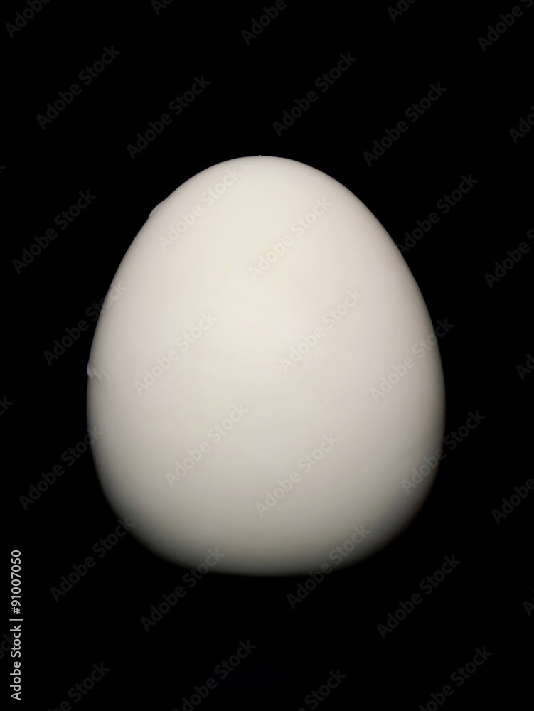 cooked egg peeled isolated on a black background cooked egg peeled isolated on a black background
