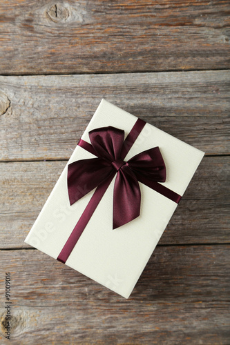 Beautiful gift box on grey wooden background