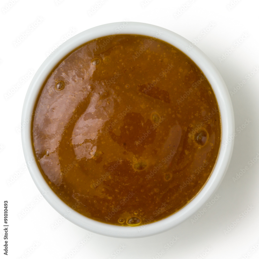 Small white pot of curry sauce dip, from above isolated on white Small white pot of curry sauce dip, from above isolated on white