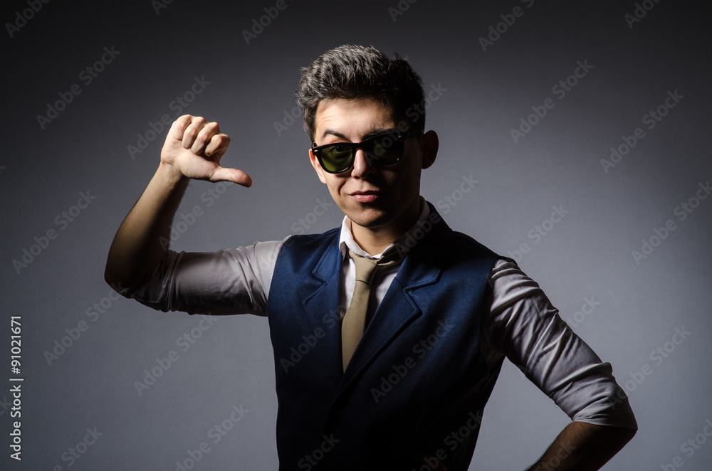 Young man in blue vest against gray Young man in blue vest against gray