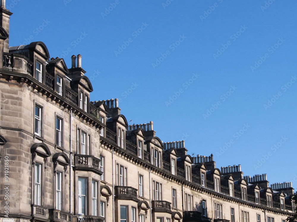 Row of houses in Edinburgh against blue sky