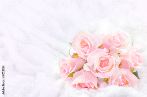 Fototapeta Naklejka Na Ścianę i Meble -  Pastel Coloured Artificial Pink Rose on white fur background