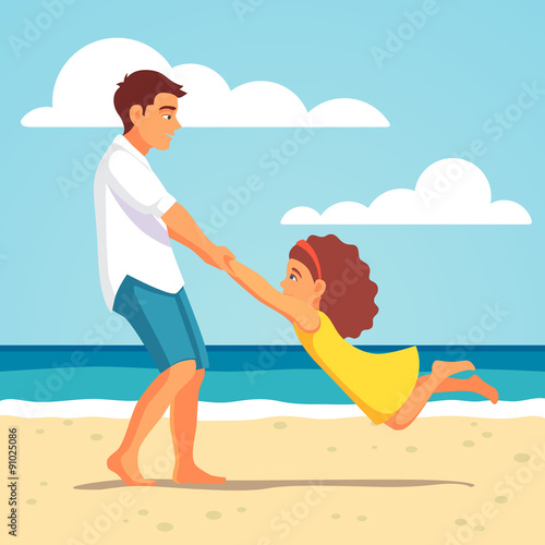 Father playing with daughter on the beach