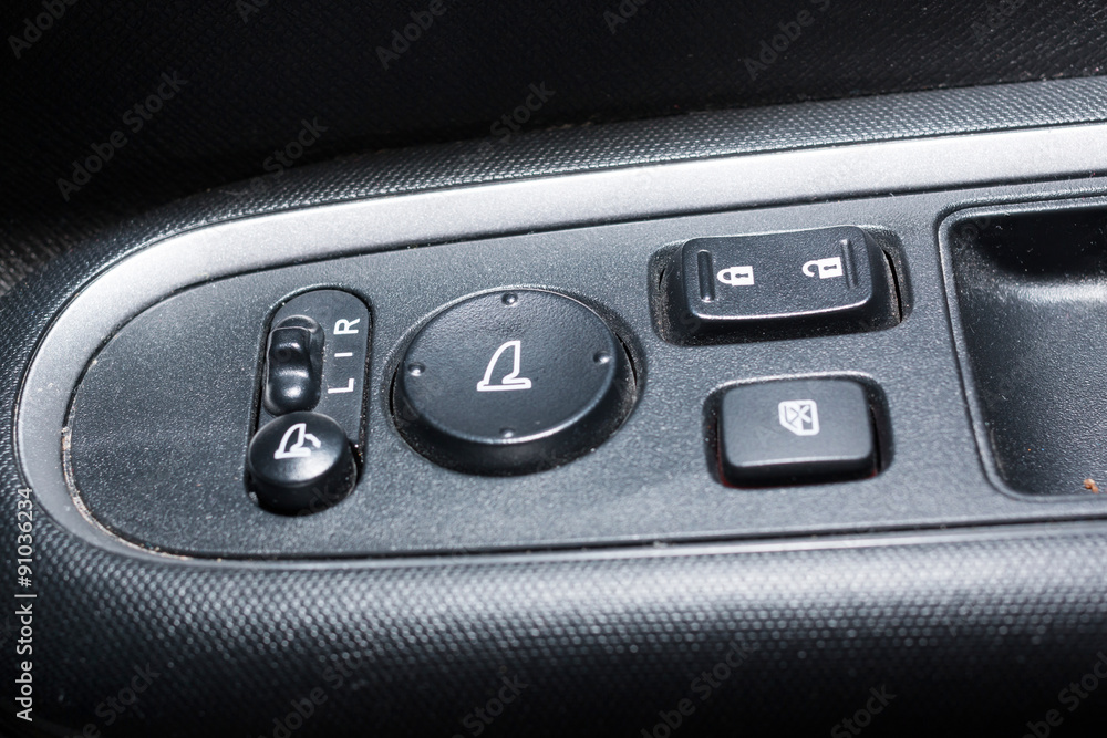 Detail on buttons controlling the windows in a car
