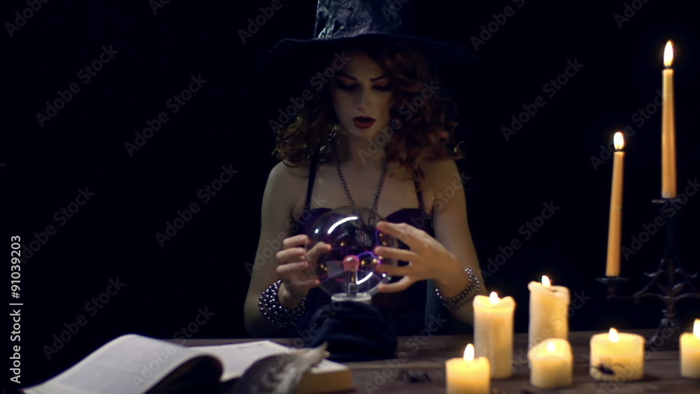 Young witch predicting the future with crystal ball Young witch predicting the future with crystal ball