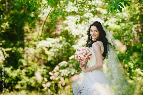 Beautiful happy young brunette bride outdoors in wedding dress,hairstyle, make-up, wedding, lifestyle