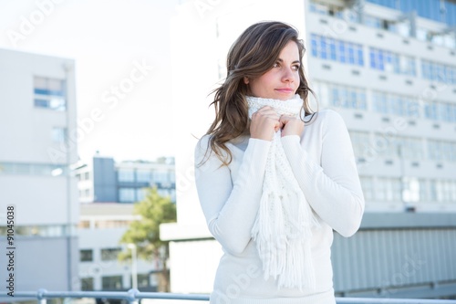Pretty woman with warm clothes looking away 