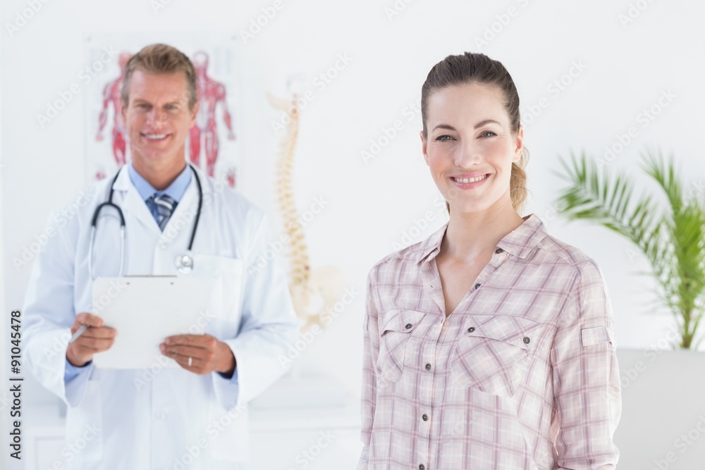 Doctor and patient smiling at camera Doctor and patient smiling at camera