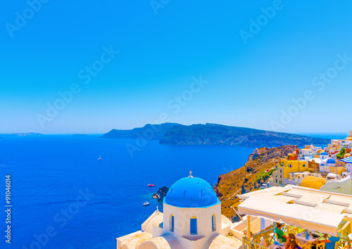 Fototapeta Naklejka Na Ścianę i Meble -  The blue colored dome of an old  traditional church in Oia the most beautiful village of Santorini island in Greece