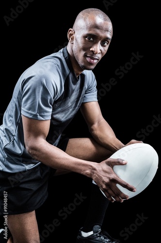 Portrait of confident rugby player with ball