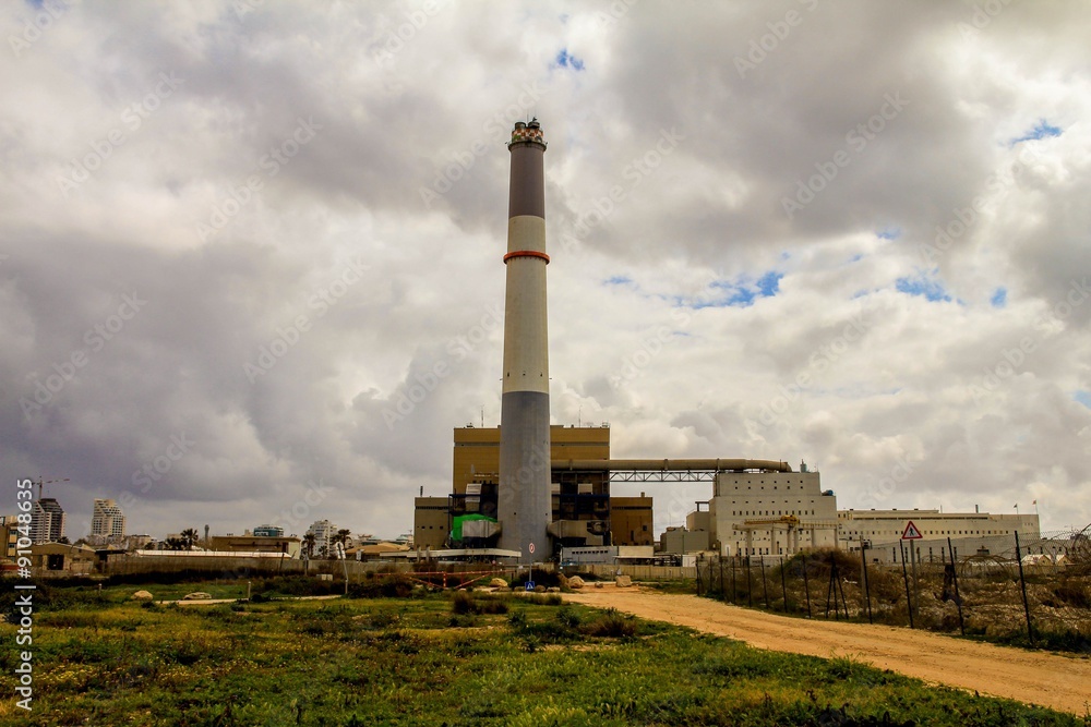 Small power plant using gas on dark stormy cloudy sky background Small power plant using gas on dark stormy cloudy sky background