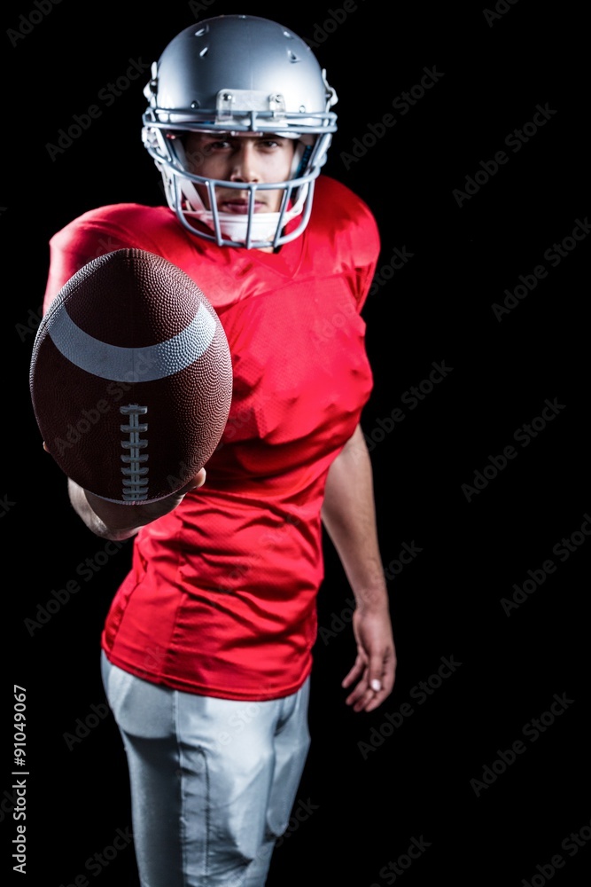 Confident American football player showing ball Confident American football player showing ball